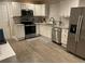 Well-lit kitchen with stainless steel appliances, granite countertops, and white cabinets at 3385 Martin Luther King Jr Sw Dr, Atlanta, GA 30331