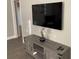 Living room featuring stylish cabinet, flat screen tv, modern flooring, and natural lighting at 3385 Martin Luther King Jr Sw Dr, Atlanta, GA 30331