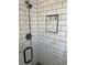 Modern shower features a glass door, and black and white tile at 3385 Martin Luther King Jr Sw Dr, Atlanta, GA 30331
