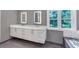 A bathroom with dual vanities and framed mirrors sits adjacent to a window at 395 Clubfield Dr, Roswell, GA 30075