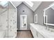 This modern bathroom features a glass enclosed shower and dual vanities at 395 Clubfield Dr, Roswell, GA 30075
