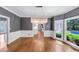 Elegant dining room boasts hardwood floors, a modern chandelier, large window with a lush outdoor view at 395 Clubfield Dr, Roswell, GA 30075