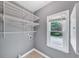 Well-lit laundry room with wire shelving and a window at 395 Clubfield Dr, Roswell, GA 30075