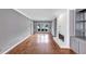 Spacious living room with hardwood floors, grey walls, fireplace, and ample natural light at 395 Clubfield Dr, Roswell, GA 30075