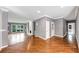 Spacious living room with hardwood floors, grey walls, fireplace, and ample natural light at 395 Clubfield Dr, Roswell, GA 30075