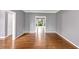 Inviting living room featuring hardwood floors, neutral walls and trim, with an open view to the home's exterior at 395 Clubfield Dr, Roswell, GA 30075