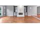 Spacious living room with hardwood floors, a fireplace, and grey walls at 395 Clubfield Dr, Roswell, GA 30075