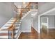Spacious staircase boasts wood treads, wrought iron spindles, wood handrail, and a large landing providing an open feel at 395 Clubfield Dr, Roswell, GA 30075