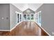 Elegant sunroom with hardwood floors, cathedral ceilings, chandelier, and large windows offering natural light at 395 Clubfield Dr, Roswell, GA 30075