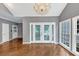 Elegant sunroom with hardwood floors, cathedral ceilings, chandelier, and large windows offering natural light at 395 Clubfield Dr, Roswell, GA 30075