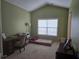 Bedroom features soft green walls, a large window, and is partially furnished as a home office at 106 Trailside Way, Hiram, GA 30141