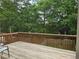 Inviting wooden deck with railing, and view of trees in the back yard at 106 Trailside Way, Hiram, GA 30141