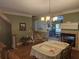 Elegant dining room with hardwood floors, fireplace, and stylish chandelier, ideal for entertaining guests at 106 Trailside Way, Hiram, GA 30141