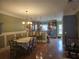 Open dining area with stylish hardwood floors, a fireplace, and seamless connection to the kitchen at 106 Trailside Way, Hiram, GA 30141