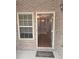 Inviting entryway featuring a 'Welcome' mat and view into a hardwood floored foyer at 106 Trailside Way, Hiram, GA 30141