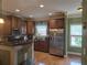 Modern kitchen featuring stainless steel appliances, granite countertops, and hardwood flooring at 106 Trailside Way, Hiram, GA 30141