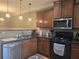Shows a kitchen with stainless appliances, stone countertops, and natural wood cabinets at 106 Trailside Way, Hiram, GA 30141