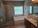 Bathroom features a walk-in shower, soaking tub, double sink vanity and large window for natural light at 106 Trailside Way, Hiram, GA 30141