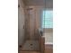 Shower in main bathroom with glass door and mosaic tile accent at 106 Trailside Way, Hiram, GA 30141