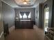 Main bedroom with neutral carpet, gray walls, tray ceiling, fan, and ensuite bathroom at 106 Trailside Way, Hiram, GA 30141
