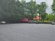 Large parking lot with a red rail car and a cabin style building in the background at 106 Trailside Way, Hiram, GA 30141