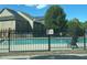 Community pool with lounge chairs, a dark fence, and a view of nearby homes at 106 Trailside Way, Hiram, GA 30141