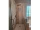 Modern bathroom featuring tiled shower with glass door and rainfall showerhead at 106 Trailside Way, Hiram, GA 30141