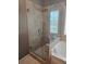Modern bathroom featuring tiled shower with glass door and rainfall showerhead at 106 Trailside Way, Hiram, GA 30141