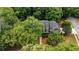 Aerial view of a beautiful home with mature trees and a well-maintained landscape at 1061 Polo Club Nw Dr, Marietta, GA 30064