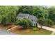 Picturesque aerial view of a home with lush greenery and a well-maintained lawn at 1061 Polo Club Nw Dr, Marietta, GA 30064