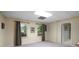 View of a finished basement with natural light, neutral paint, and access to another room at 1061 Polo Club Nw Dr, Marietta, GA 30064