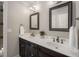 Well-appointed bathroom with dual sinks, quartz countertops, dark cabinetry, and modern fixtures providing functionality and style at 1061 Polo Club Nw Dr, Marietta, GA 30064