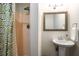 A partial bathroom showcasing a vibrant shower curtain, walk-in shower, and pedestal sink at 1061 Polo Club Nw Dr, Marietta, GA 30064