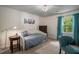 Comfortable bedroom with blue accents features lawn view from window with blue curtains at 1061 Polo Club Nw Dr, Marietta, GA 30064