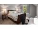Cozy bedroom offers natural light, with view of mature trees, from window with plantation shutters at 1061 Polo Club Nw Dr, Marietta, GA 30064