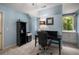Bedroom with desk, shelving, and built-in cabinets gets natural light from window with lawn view at 1061 Polo Club Nw Dr, Marietta, GA 30064