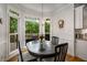 Cozy breakfast nook featuring a table, chandelier, and serene backyard view at 1061 Polo Club Nw Dr, Marietta, GA 30064