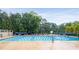 Community pool with lounge chairs and mature trees at 1061 Polo Club Nw Dr, Marietta, GA 30064