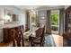 Bright dining room with large window view, elegant chandelier, hardwood floors, and refined wood furniture for sophisticated dining at 1061 Polo Club Nw Dr, Marietta, GA 30064