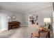 Spacious living room with piano, cozy seating, and seamless flow into a naturally lit room with a fireplace at 1061 Polo Club Nw Dr, Marietta, GA 30064