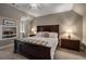 Cozy main bedroom with neutral tones, carpet, ample lighting, and classic dark wood bedroom furniture for restful relaxation at 1061 Polo Club Nw Dr, Marietta, GA 30064