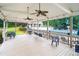 Outdoor patio with ceiling fans, chairs, and view of the pool and clubhouse at 1061 Polo Club Nw Dr, Marietta, GA 30064