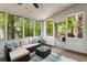 Serene sunroom featuring a cozy sectional, outdoor views, and natural light for relaxation and enjoyment at 1061 Polo Club Nw Dr, Marietta, GA 30064
