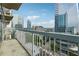 Balcony overlooking city buildings with metal railing on a partly cloudy day at 3324 Peachtree Ne Rd # 1407, Atlanta, GA 30326