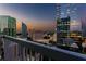 Balcony with metal railing overlooks city buildings during sunset at 3324 Peachtree Ne Rd # 1407, Atlanta, GA 30326