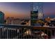 Balcony with metal railing overlooks city buildings during sunset at 3324 Peachtree Ne Rd # 1407, Atlanta, GA 30326