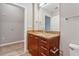 Modern bathroom features a wood vanity with granite countertop and neutral wall paint at 3324 Peachtree Ne Rd # 1407, Atlanta, GA 30326