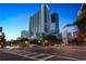 Street view of modern high-rise building with distinctive architecture, enhanced by evening lights and lush trees at 3324 Peachtree Ne Rd # 1407, Atlanta, GA 30326