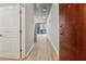 Inviting hallway with hardwood floors, neutral walls, and a glimpse of city views through the end windows at 3324 Peachtree Ne Rd # 1407, Atlanta, GA 30326