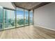 Bright living room with hardwood floors, large windows with skyline views, and modern lighting fixture at 3324 Peachtree Ne Rd # 1407, Atlanta, GA 30326